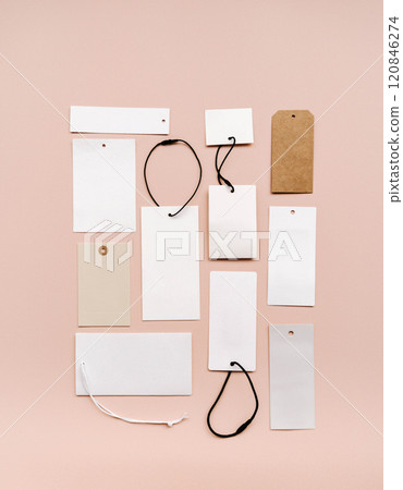 White price labels, blank tags with different shapes and sizes on a beige background. White price labels, blank tags with different shapes and sizes on a beige background. 120846274