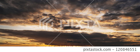 orange sunset in cloudy sky with clouds at sunset in the evening. Panoramic background with sky orange sunset in cloudy sky with clouds at sunset in the evening. Panoramic background with sky 120846551