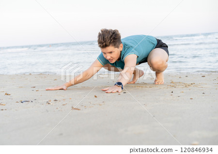 Sporty woman is engaged in animal flow gymnastics outdoors on sea beach. Female trains with Animal Flow workout to elevate her body weight workout. Innovative animal instinct fitness sport movement. Sporty woman is engaged in animal flow gymnastics outdoors on sea beach. Female trains with Animal Flow workout to elevate her body weight workout. Innovative animal instinct fitness sport movement. 120846934