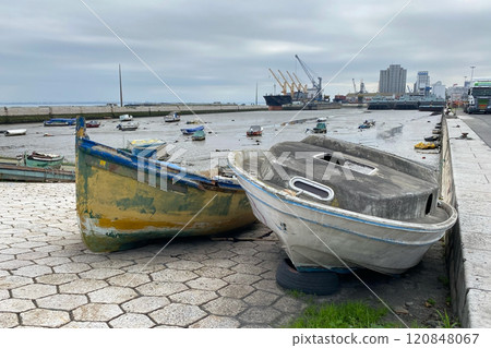 Old ruined wooden boat on the shore near the water 120848067
