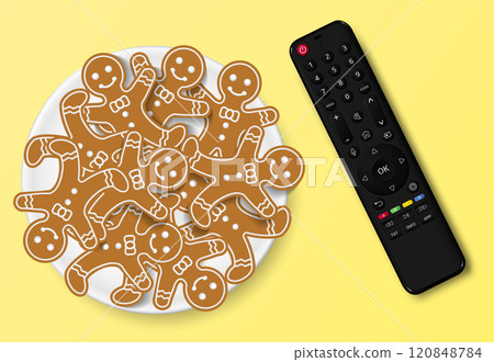 Modern smart TV remote control with Christmas gingerbread cookies Modern smart TV remote control with Christmas gingerbread cookies 120848784