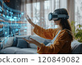 Woman Interacting with Holographic Display Using VR Headset 120849082