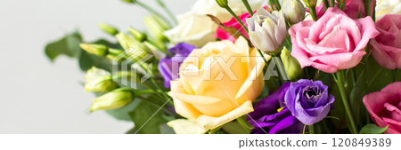 This seasonal bouquet of roses, eucalyptus, and eustoma in soft pink, white, and purple tones makes an ideal gift for anniversaries, birthdays, or any special event, banner 120849389