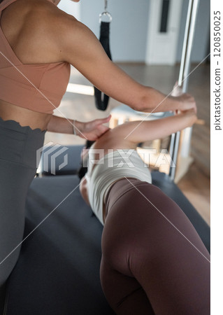 A detailed closeup of hip opening exercises and core exercise on a Balanced Body Reformer machine illuminated by sunlight A detailed closeup of hip opening exercises and core exercise on a Balanced Body Reformer machine illuminated by sunlight 120850025