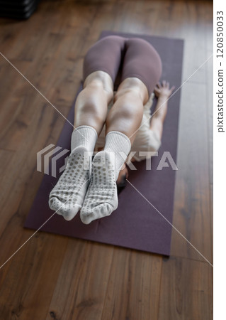 Yoga Instruction Exploring the Enhanced Partner Stretching Technique with in a Studio. Inversion pose to enhance flexibility and balance 120850033