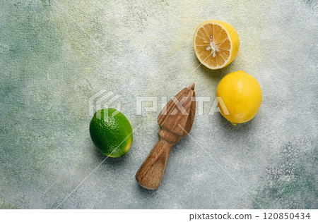 Wooden citrus reamer, manual lemon juicer, made of acacia wood, with citrus fruits on the table, top view, Wooden citrus reamer, manual lemon juicer, made of acacia wood, with citrus fruits on the table, top view, 120850434
