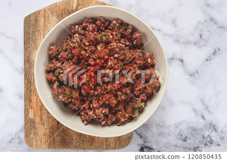 raw minced meat, marinated with spices and herbs, in a bowl, minced meat with spices, top view, homemade, no people, raw minced meat, marinated with spices and herbs, in a bowl, minced meat with spices, top view, homemade, no people, 120850435