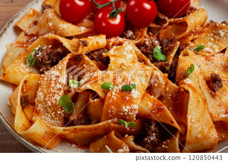 pappardelle pasta with bolognese sauce, topped with parmesan cheese and cherry branch, homemade, no people, 120850443