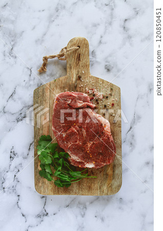 raw pork steak , pork neck, on a chopping board, marble table, top view, with spices and coriander, no people, 120850451