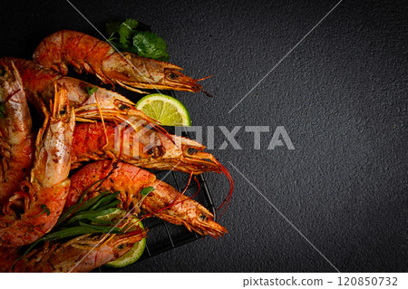 Langoustines, Australian, freshly frozen on ice, top view, lime and greens, 120850732