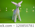 Stylized White Moose Figurine displayed on a vibrant Green Background for artistic appeal 120850781