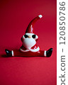 This charming and festive Santa figurine is designed in a playful pose that radiates holiday cheer 120850786