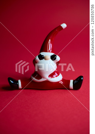 This charming and festive Santa figurine is designed in a playful pose that radiates holiday cheer 120850786