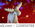 A Beautiful White Moose Figurine Set Against a Bright and Colorful Bokeh Background 120850788