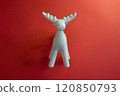 A Stylish White Moose Figurine Set Against a Bright Red Background to Enhance Its Appeal 120850793