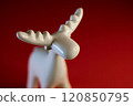 A stylized White Moose Figurine on a vibrant red background, perfect for display 120850795