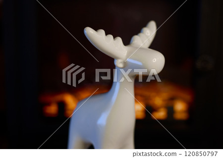 A Stylish White Moose Figurine Perfectly Positioned Against a Beautifully Cozy Background A Stylish White Moose Figurine Perfectly Positioned Against a Beautifully Cozy Background 120850797