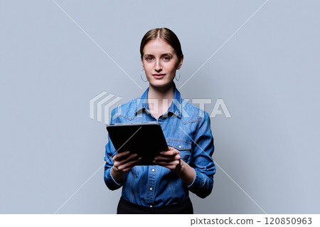 Teenager student girl with digital tablet on grey studio background 120850963