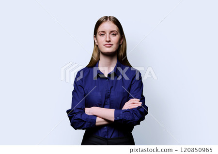 Beautiful young girl with crossed arms looking at camera on white background Beautiful young girl with crossed arms looking at camera on white background 120850965