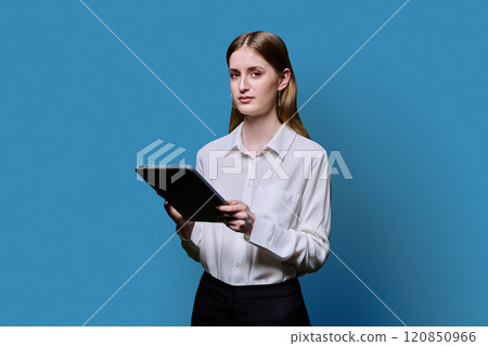Teenager student girl with digital tablet on blue studio background 120850966