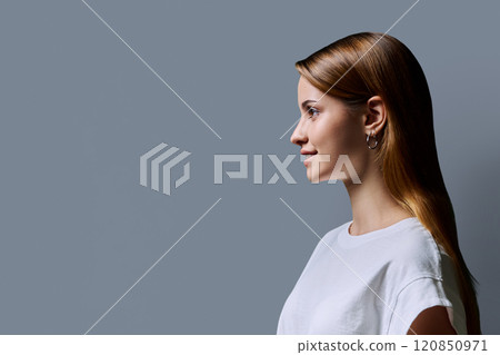 Profile portrait of young teenage girl, gray studio copy space background 120850971