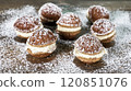 Chocolate pastries filled with creamy frosting are scattered on a rustic wooden surface and topped with powdered sugar. 120851076