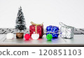 Miniature Christmas decorations on a laptop keyboard create a festive atmosphere in a modern workspace 120851103