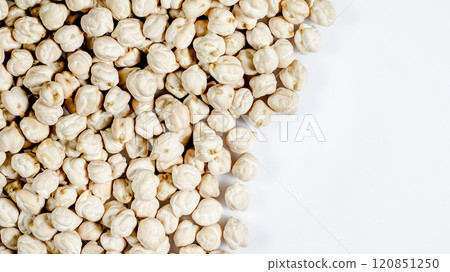 Chickpeas spread across a white surface showcasing their unique texture and shape in a natural light setting 120851250