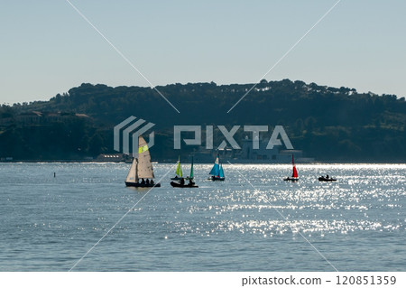 small boats with colorful sails, sailboats on the river at sunset 120851359