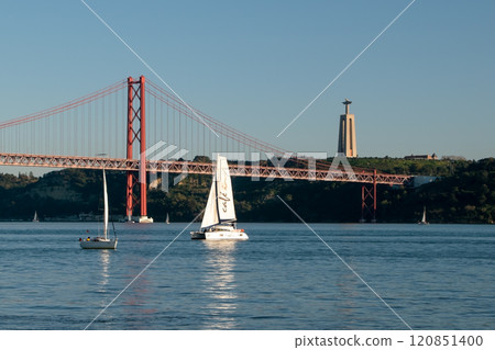 small boats with colorful sails, sailboats on the river at sunset 120851400