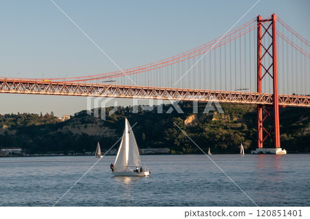 small boats with colorful sails, sailboats on the river at sunset 120851401