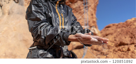 Girl is climbing with magnesium powder on the rocks. Girl is climbing with magnesium powder on the rocks. 120851892