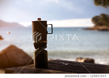 Landscape with camping burner on the foreground. Landscape with camping burner on the foreground. 120851915