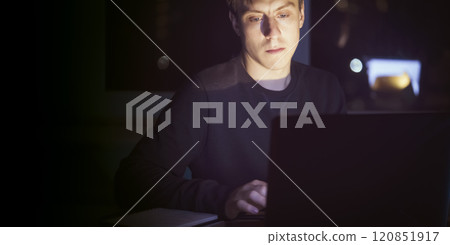 Man is working on a laptop at night. Man is working on a laptop at night. 120851917
