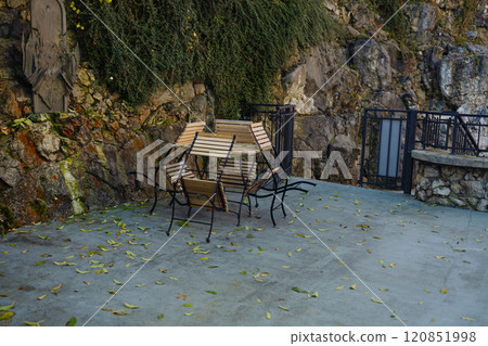 Outdoor dining patio with plants (empty, no people) restaurant outside seating tables chairs Outdoor dining patio with plants (empty, no people) restaurant outside seating tables chairs 120851998
