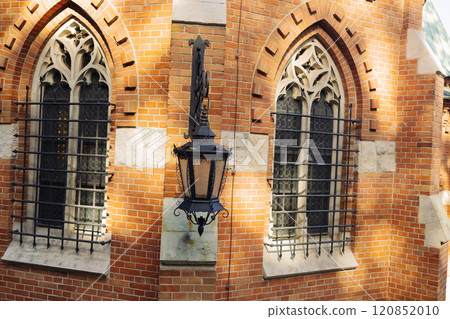 Vintage lantern and traditional old houses in Krakow, Poland. Vintage gasoline oil lantern lamp with a soft glow light 120852010