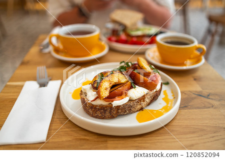 Breakfast sandwiches bread toast, bruschetta with grilled peaches and cheese. Healthy appetizer or snack. Food recipe background. Close up, Breakfast sandwiches bread toast, bruschetta with grilled peaches and cheese. Healthy appetizer or snack. Food recipe background. Close up, 120852094