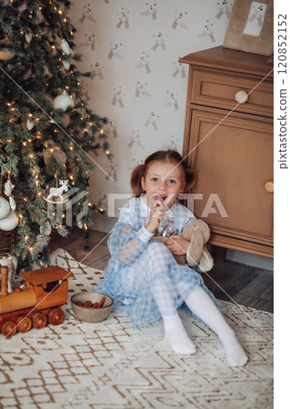 Baby girl cute in a beautiful dress near the 120852152