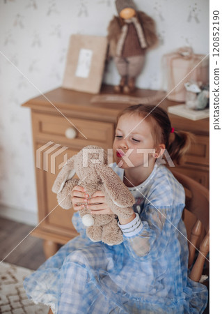 Baby girl cute in a beautiful dress near the 120852190