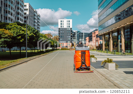 Cityscape of a residential area with modern apartment buildings, new green urban landscape in the city.Street cleaner, road sweeper cleaning on the floor in city of Krakow, Poland. Cityscape of a residential area with modern apartment buildings, new green urban landscape in the city.Street cleaner, road sweeper cleaning on the floor in city of Krakow, Poland. 120852211