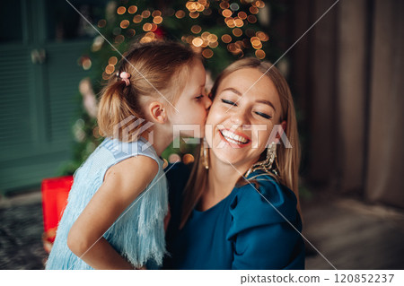 Little girl and her mom on Christmas morning at 120852237
