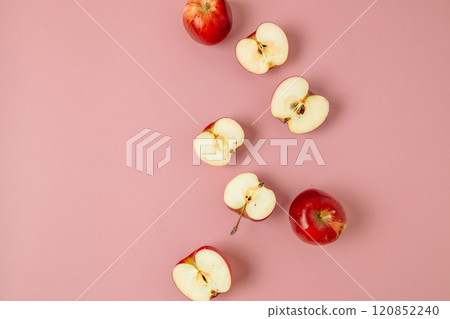 Red apple, half apple and quarter apple on pink background. Top view, healthy food concept. Top view. 120852240