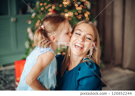 Little girl and her mom on Christmas morning at 120852244