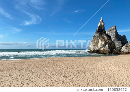 Empty wild sandy beach, Atlantic Ocean seascape, sea waves, beautiful cloudscape, dramatic landscape, travel content, Lisbon, Portugal 120852652