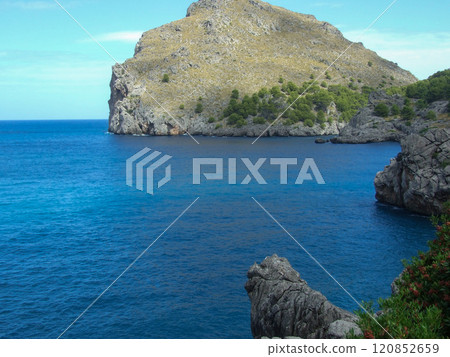 Rocky shore with blue coastal view Rocky shore with blue coastal view 120852659