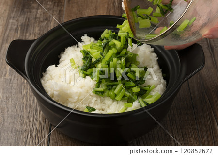 Vegetable rice: White rice cooked in a clay pot mixed with boiled turnip leaves 120852672