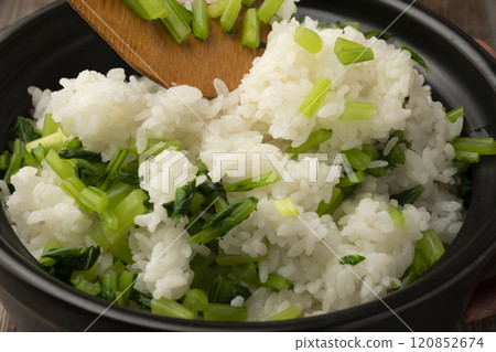 Vegetable rice: White rice cooked in a clay pot mixed with boiled turnip leaves 120852674