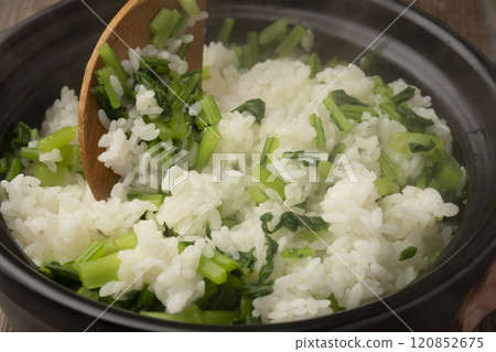 Vegetable rice: White rice cooked in a clay pot mixed with boiled turnip leaves 120852675