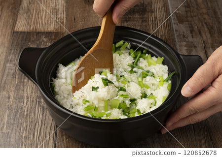 Vegetable rice: White rice cooked in a clay pot mixed with boiled turnip leaves 120852678