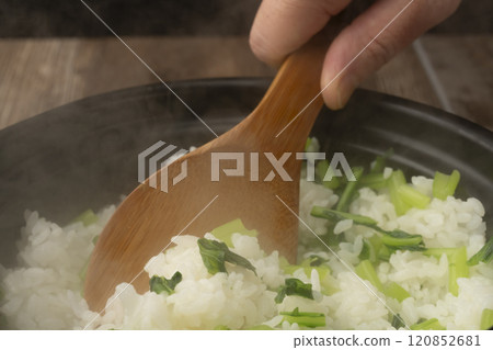 Vegetable rice: White rice cooked in a clay pot mixed with boiled turnip leaves 120852681